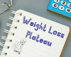 person celebrating breaking through a weight loss plateau