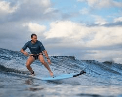 surfer riding a wave, symbolizing good health and energy